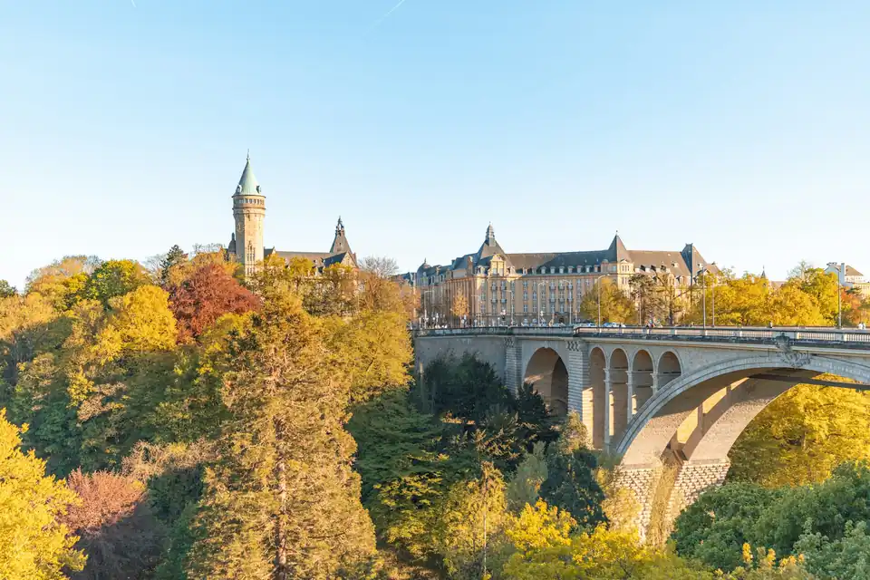 Adolphe Bridge and the Spuerkeess tower surrounded by autumn trees