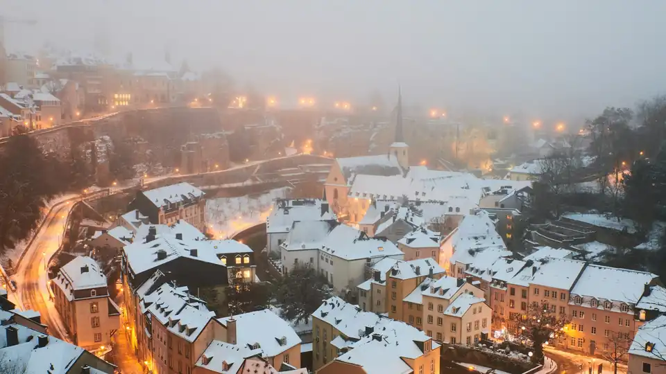 Snow-covered rooftops of the Grund at dusk