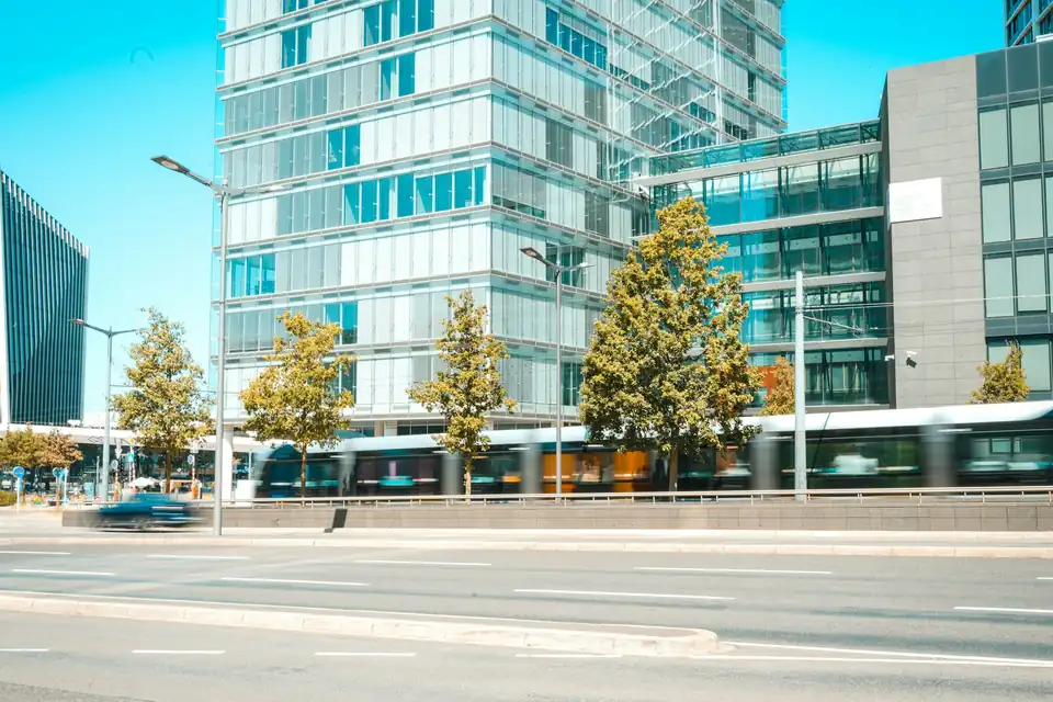 Tram passing office buildings on Avenue John F. Kennedy, Kirchberg