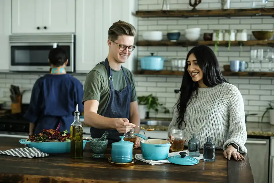 Flatmates cooking together in a kitchen
