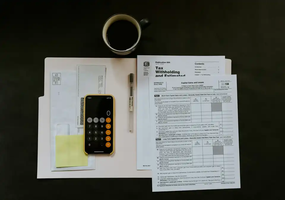 Forms, calculator and coffee on a desk