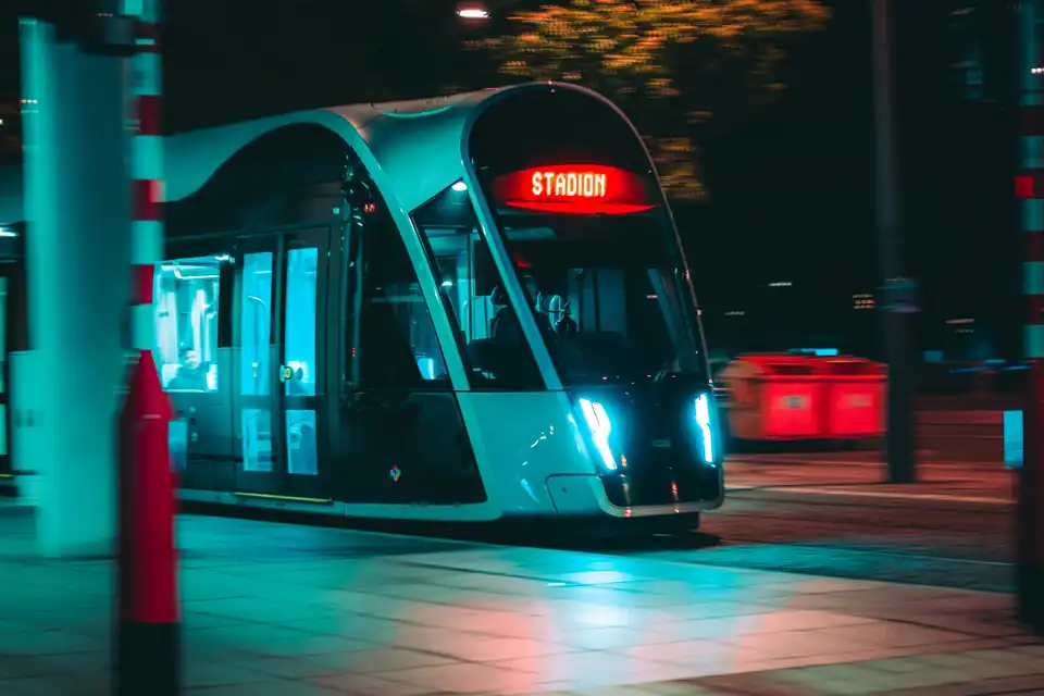 Luxembourg tram arriving at a stop at night