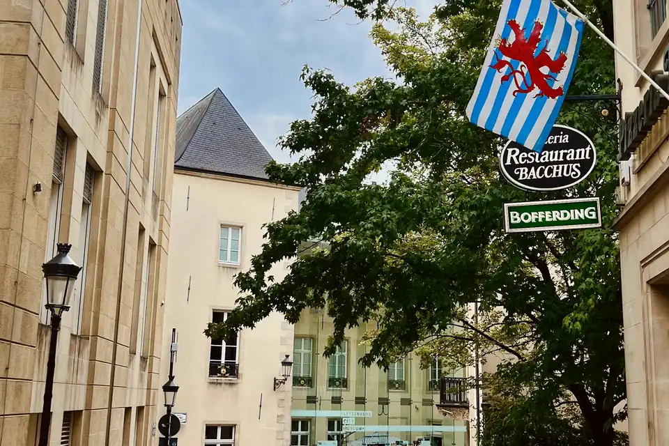 Cobbled side street with a Luxembourg City flag in Ville Haute